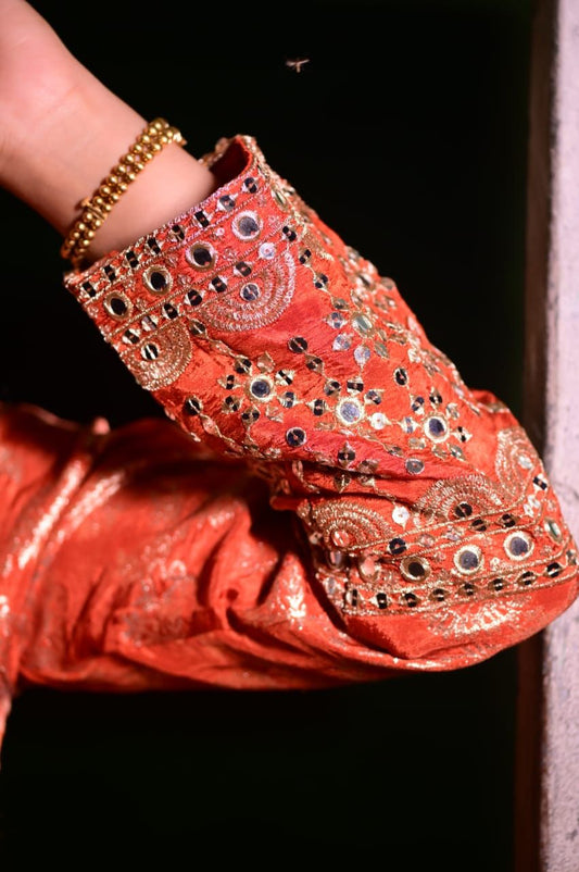 Orange Anarkali in all over golden weaving– A stunning statement piece with rich,