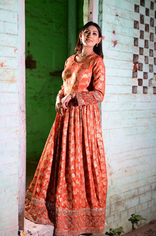 Orange Anarkali in all over golden weaving– A stunning statement piece with rich,