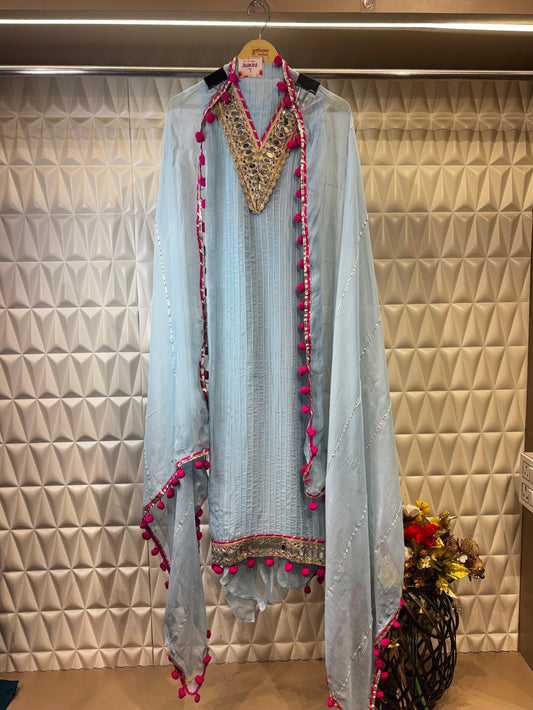 A graceful sky blue organza suit adorned with delicate mirror detailing along the neckline