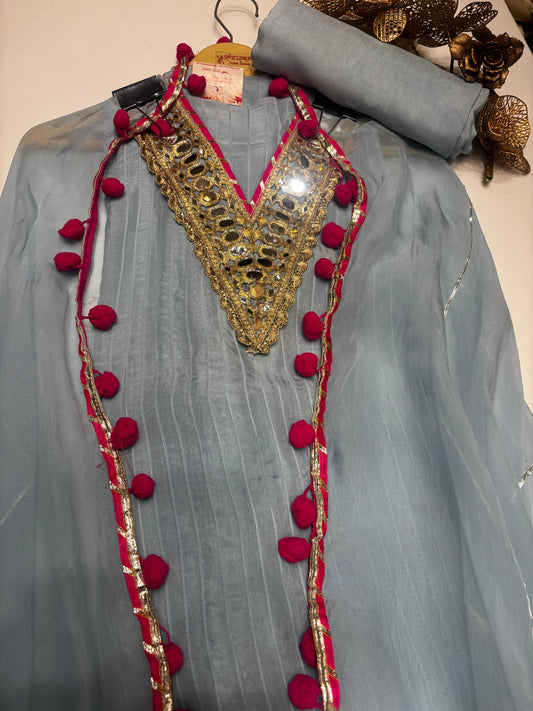 A graceful sky blue organza suit adorned with delicate mirror detailing along the neckline