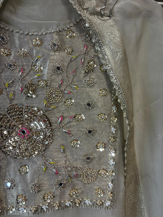 An elegant organza tissue suit featuring a beautifully hand-embroidered neckline