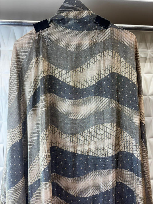 An elegant organza tissue suit featuring a beautifully hand-embroidered neckline